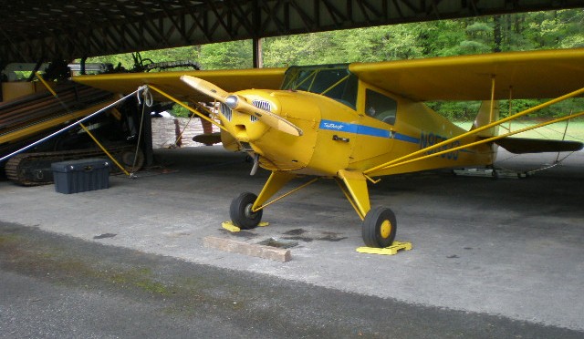 Yellow Joe Whitford Inc. Piper J3C-65 at its hangar